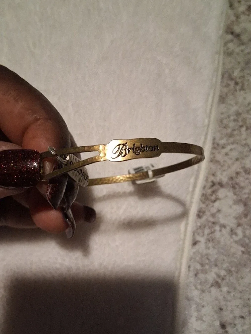 A.  Brighton Gold Tone Bangle with 'Courage' Charm